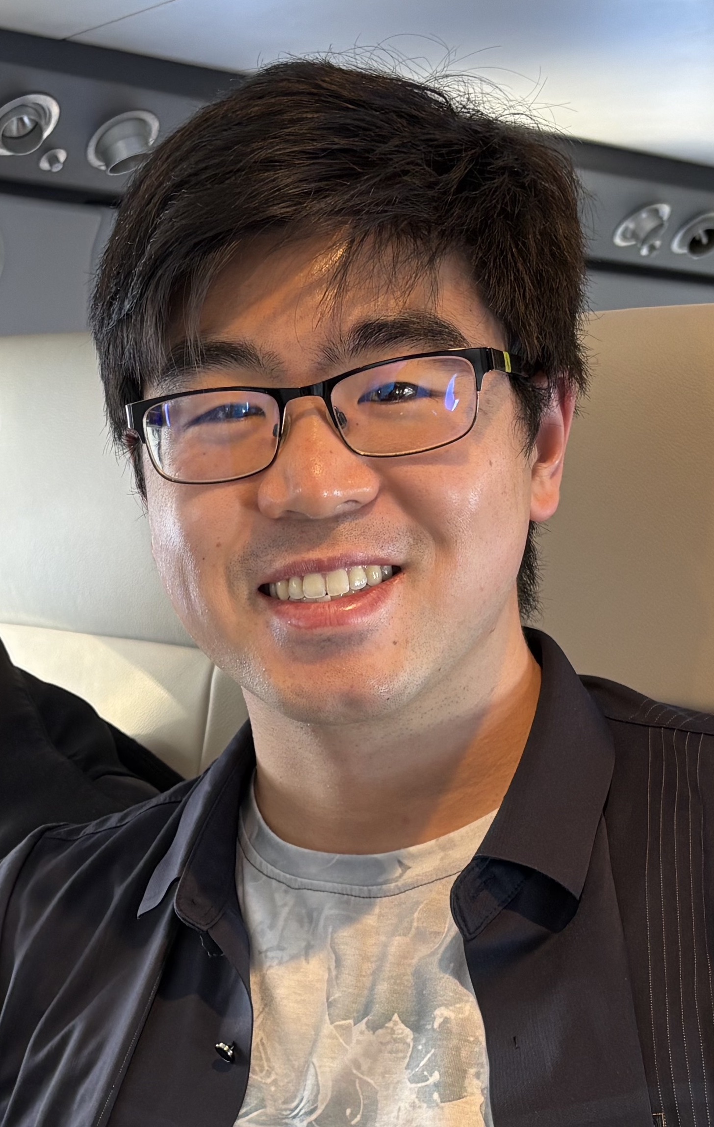 Michael Chang smiling on a plane.
